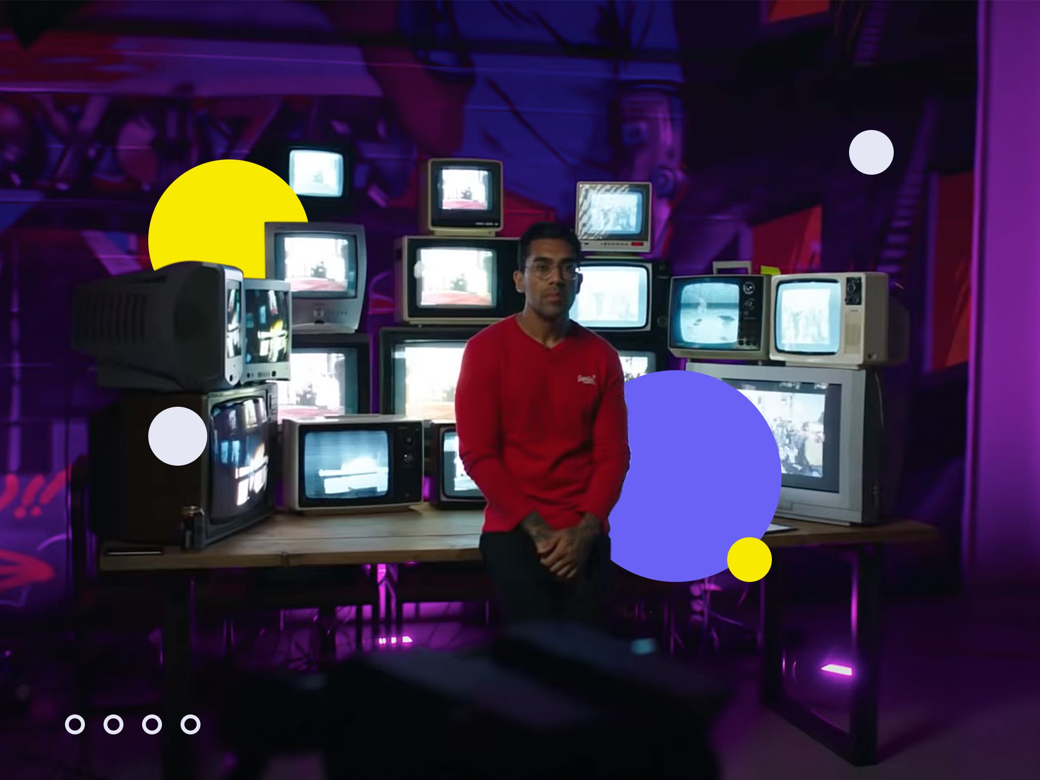 Man in front of a stack of TVs – image being used for an article on paid advertising.