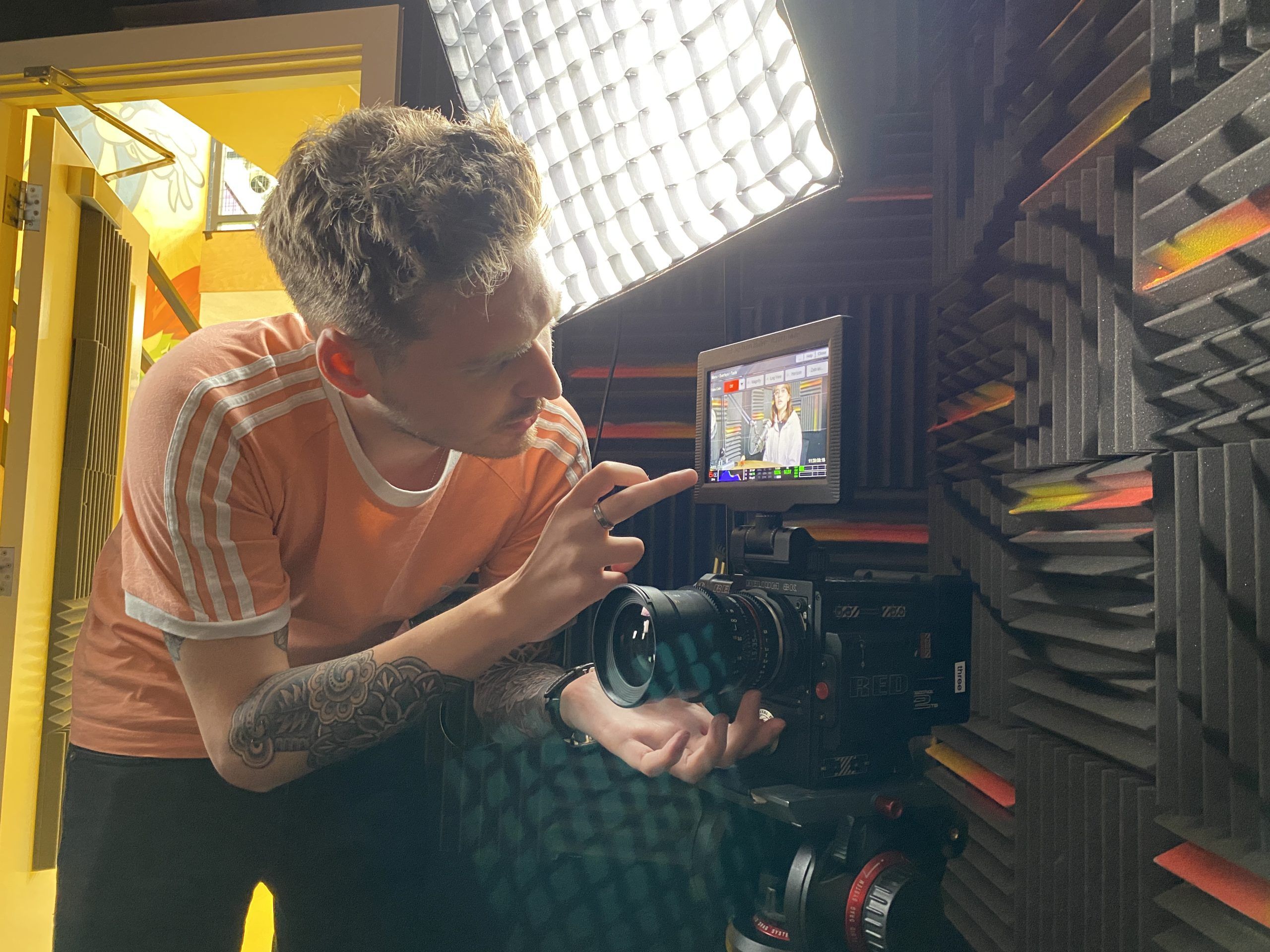Man setting up camera and lighting equipment for a blog on video testimonials